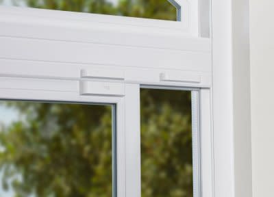 An open sliding window with a Ring Alarm Contact Sensor Open Window Magnet installed. 