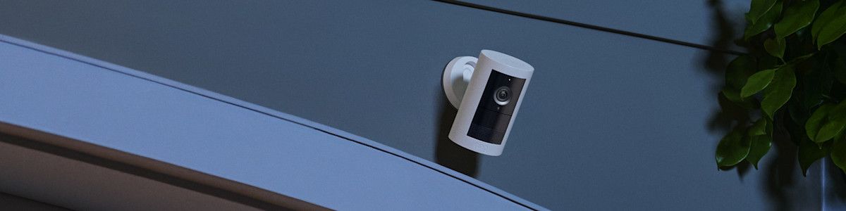 White Ring Security Camera mounted on wall in dark setting