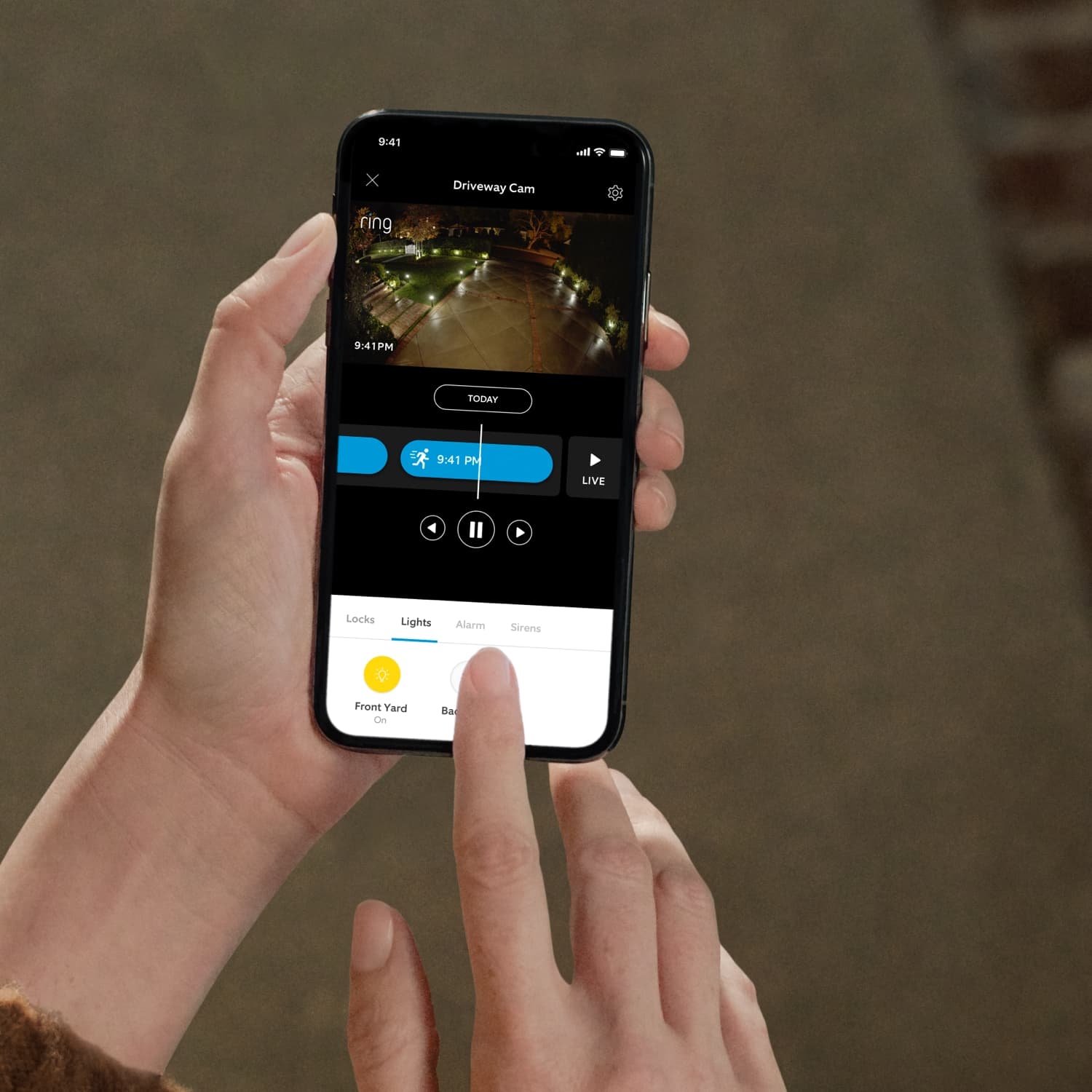 Smart Lighting A19 Smart LED Bulb - Person using Ring App to view driveway camera footage and control smart lights with 'Front Yard' light toggled on.