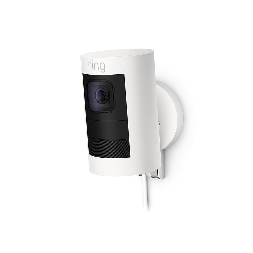 Stick Up Cam Elite with PoE Adapter - White Ring Stick Up Cam Elite security camera with black faceplate, mounted on a wall with a cable connected to its Power over Ethernet PoE adapter.