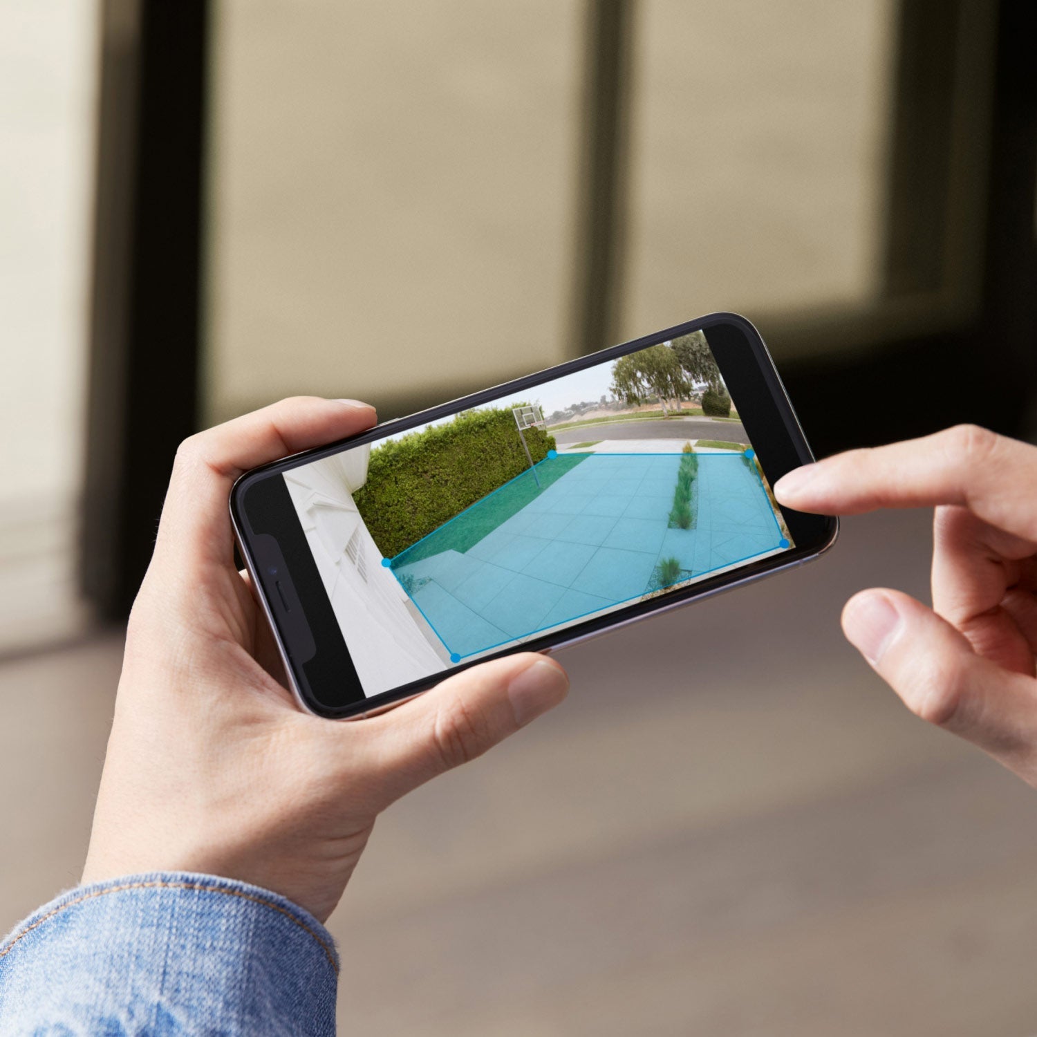 Spotlight Cam Plus - Plug-In:Ring App showing customizable motion detection zone outlined in blue over a driveway and walkway in daylight.