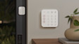A white Ring Alarm Base Station and Contact Sensor mounted on a wall and door frame