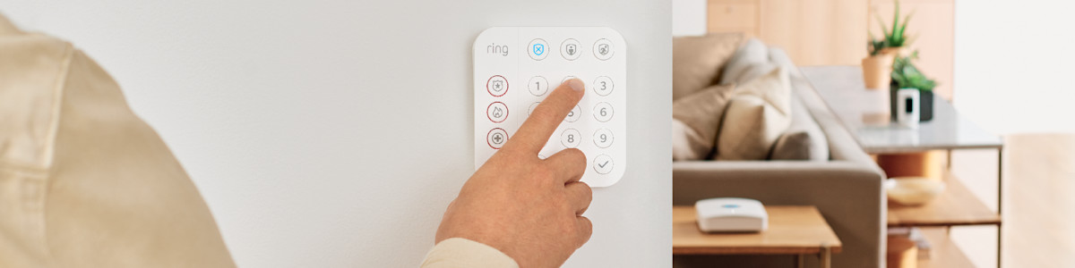 Finger pressing a button on a Ring Alarm Keypad