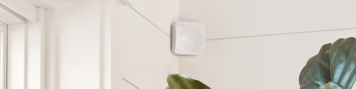White Ring Motion Detector mounted on wall near window blinds