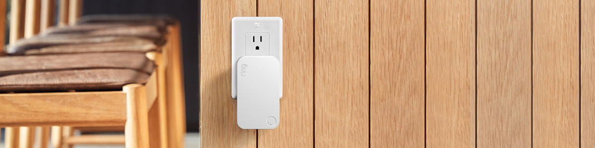 White Ring Range Extender plugged into a power point on a wooden wall