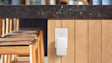 White Ring Range Extender plugged into a power point on a wooden wall