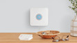Ring Alarm Pro mounted on the wall above a console table in a modern home.