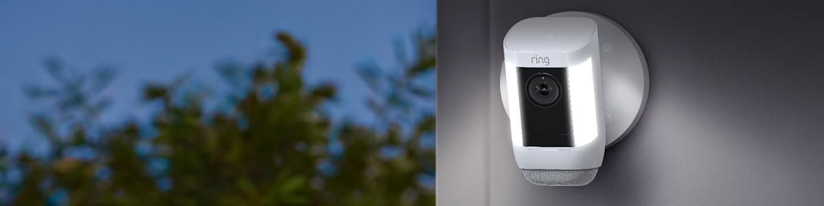 Ring security camera mounted on exterior wall with LED lights