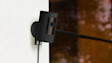 Black Ring security camera mounted on white wall