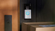 Ring Video Doorbell mounted on wooden door frame with packages below