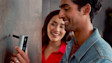 Couple smiling while looking at a Ring Video doorbell