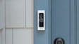 Ring Video Doorbell mounted on light blue door frame