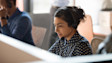 Customer service representative in polka dot blouse wearing headset