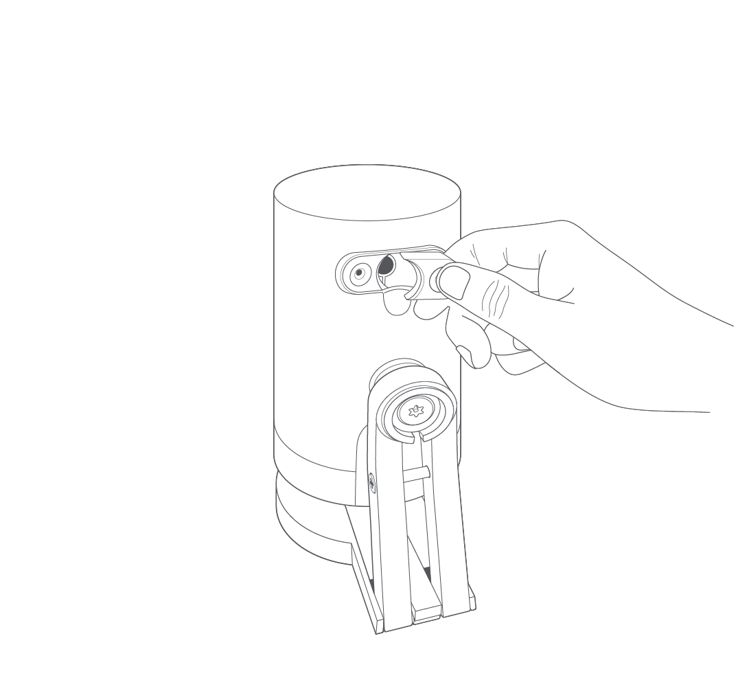 Illustration of the back of a camera showing the removal of the rubber plug from the rear of your Stick Up Cam unit.